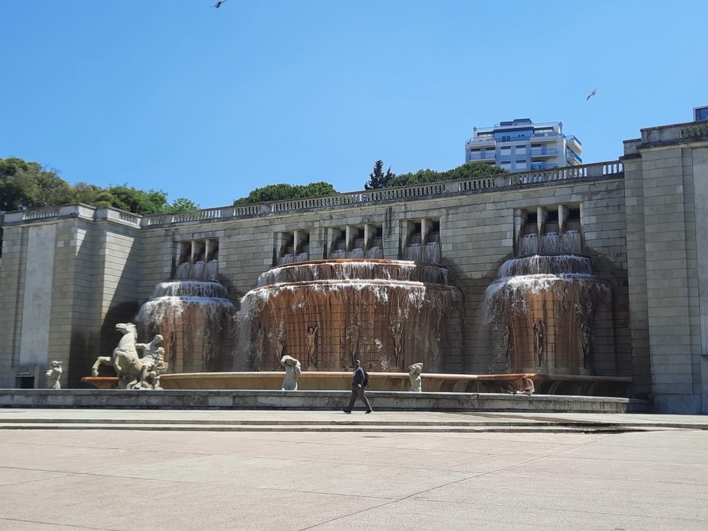 a large fountain with water running down the sides