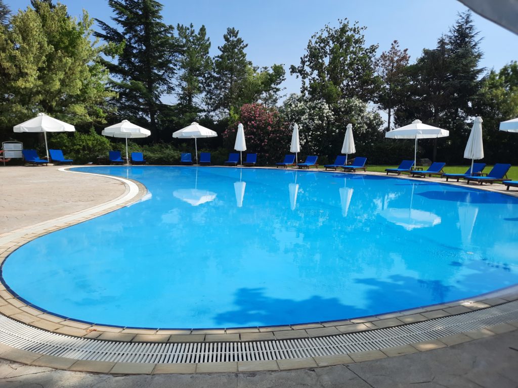 a pool with umbrellas and chairs