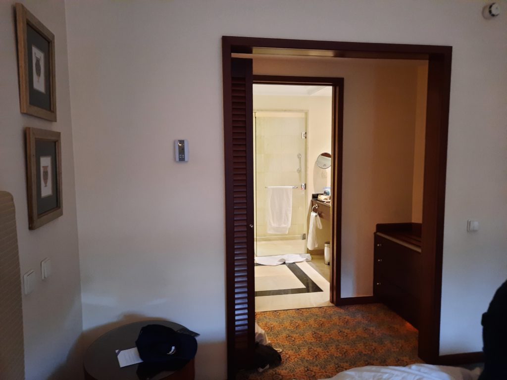 a room with a door open and a mirror
