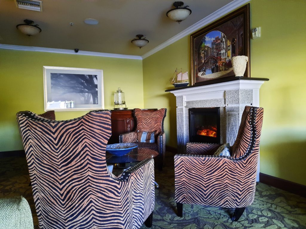 a room with a fireplace and chairs