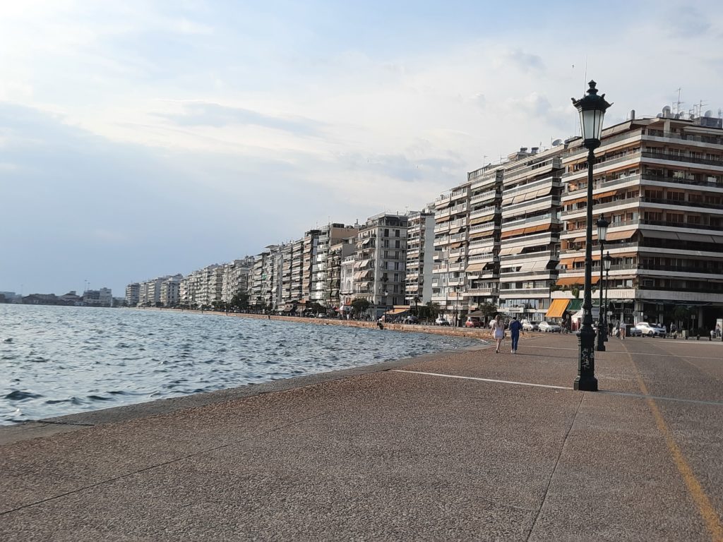 a beach with buildings and water