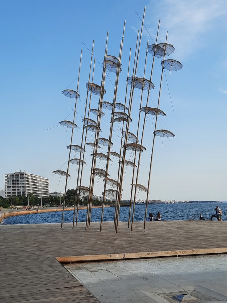 a sculpture of umbrellas on a dock