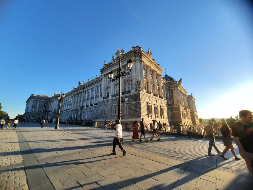 a large building with people walking in front of it