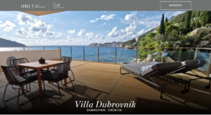 a deck with chairs and a view of the ocean