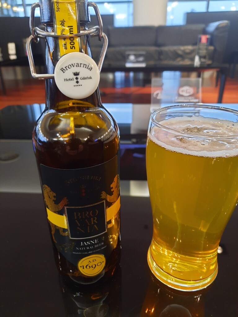 a glass of beer next to a bottle