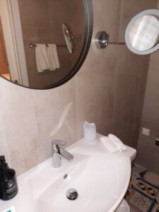 a bathroom with a round mirror