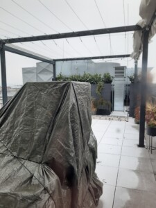 a covered patio with a grey tarp