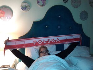 a woman lying in bed with a sign over her head