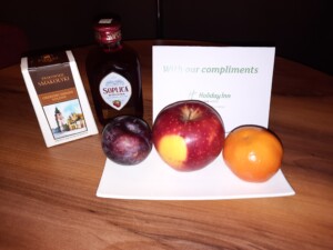 a plate of fruit and juice on a table