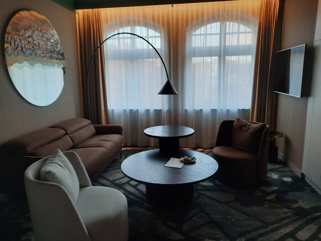 a living room with a round table and a round lamp