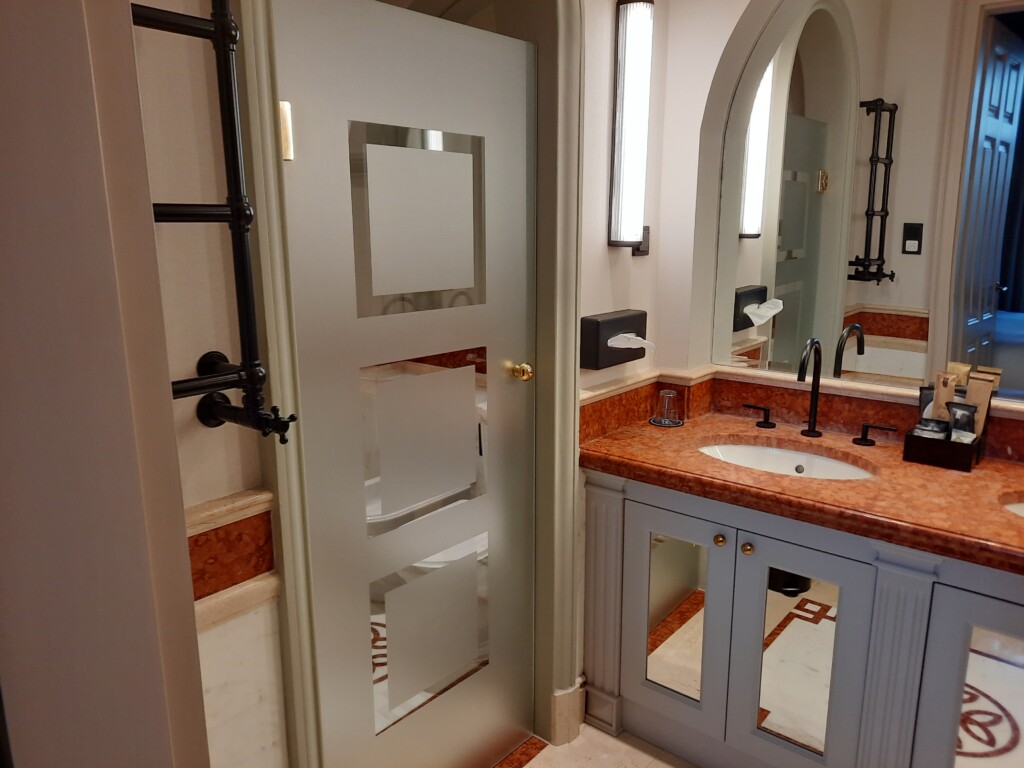 a bathroom with a door and sink
