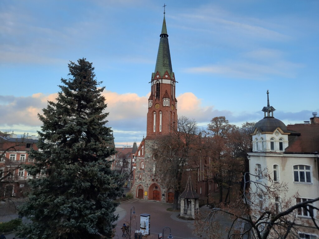 a building with a steeple and trees