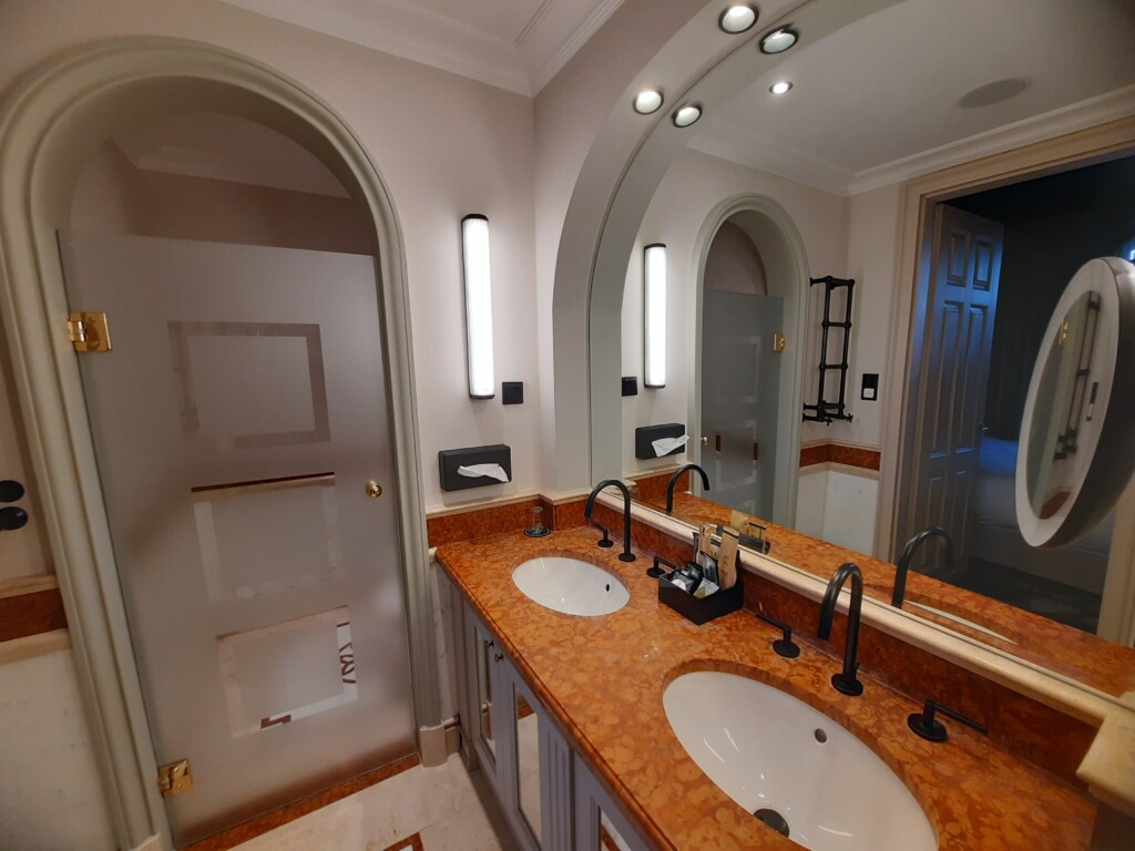 a bathroom with a double sink and a mirror