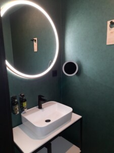 a sink and a round mirror