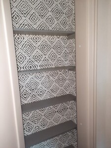 a shelf with a patterned wallpaper