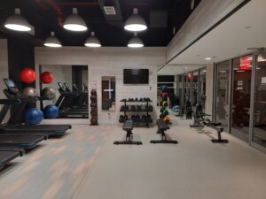 a room with exercise equipment and a mirror wall