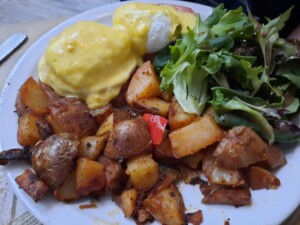 a plate of food with eggs and potatoes