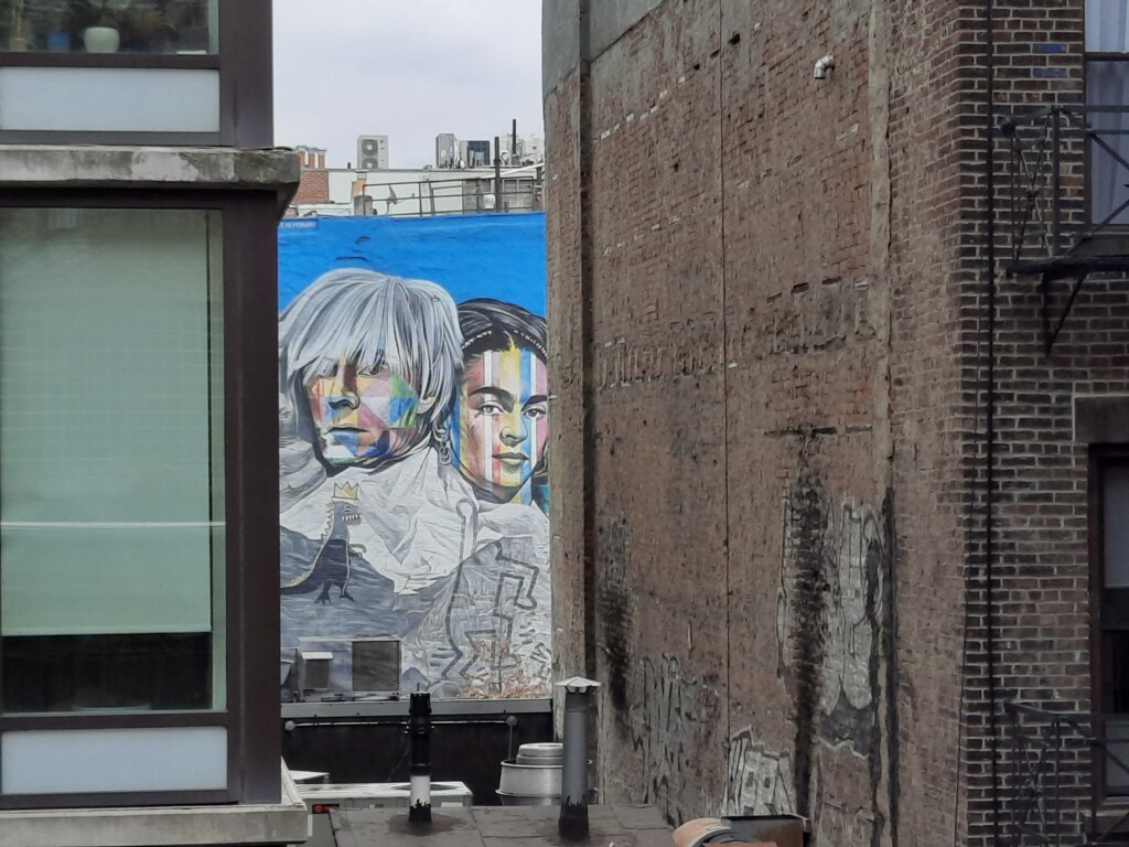 a mural of two men and a woman
