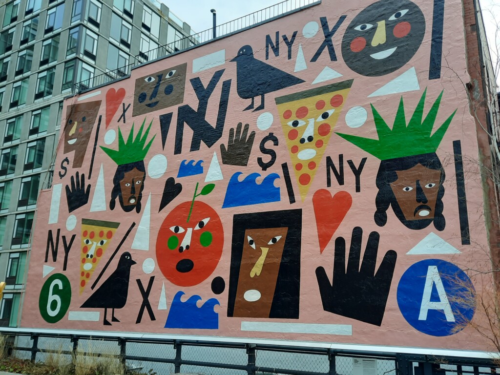 a mural of various faces and letters on a building