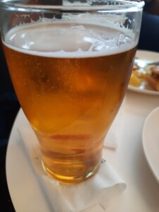 a glass of beer on a plate