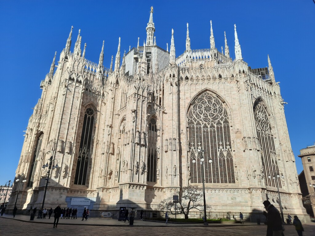 a large white building with many spires with Milan Cathedral in the background