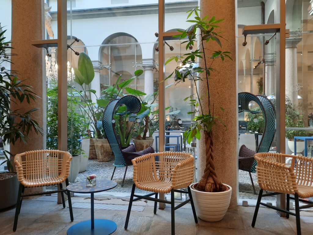 a room with chairs and tables and plants