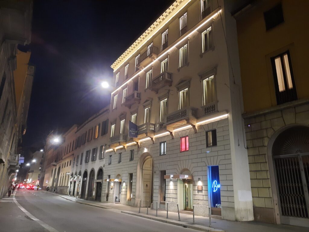 a building with lights on the side of the road