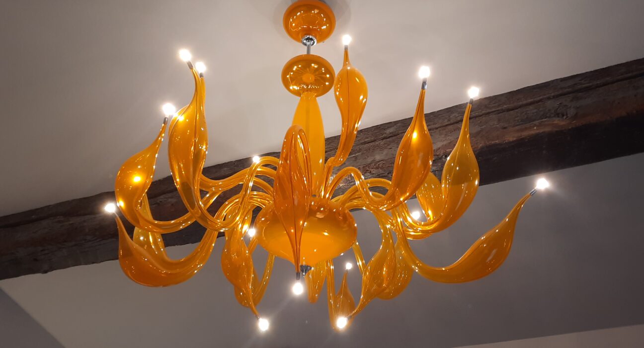 a chandelier with lights from the ceiling