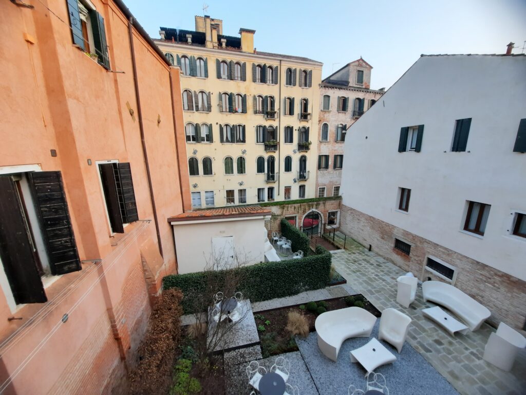 a courtyard with chairs and tables in a courtyard