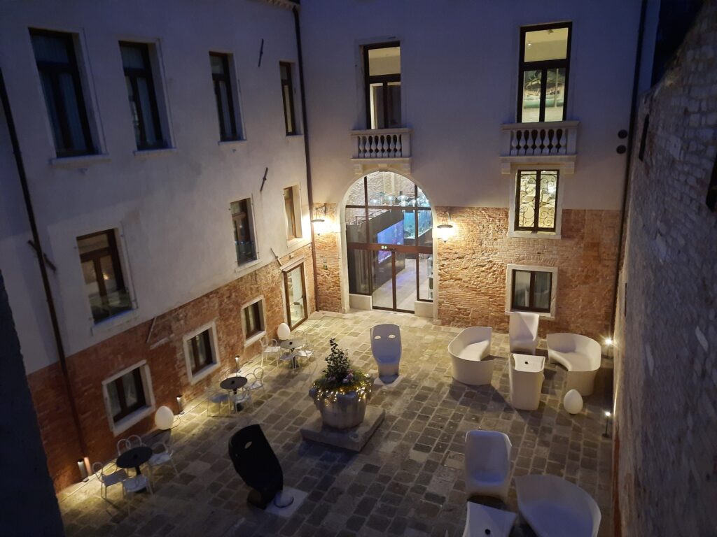 a courtyard with chairs and tables