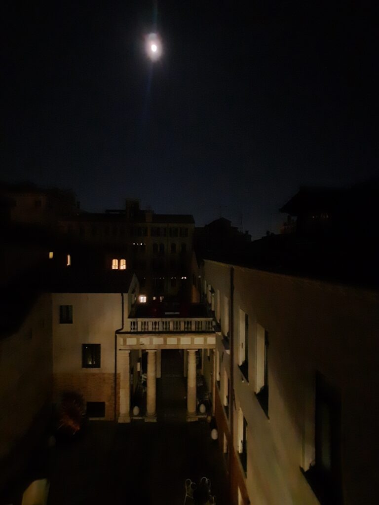 a moon over a building