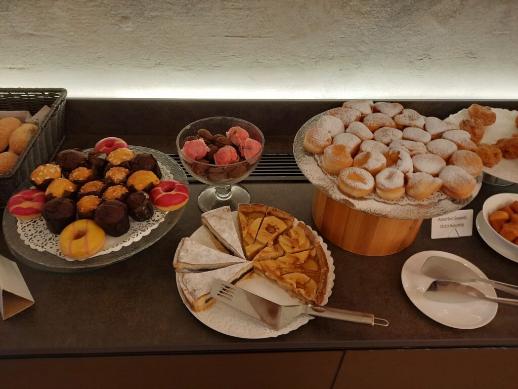 a table with different pastries and desserts