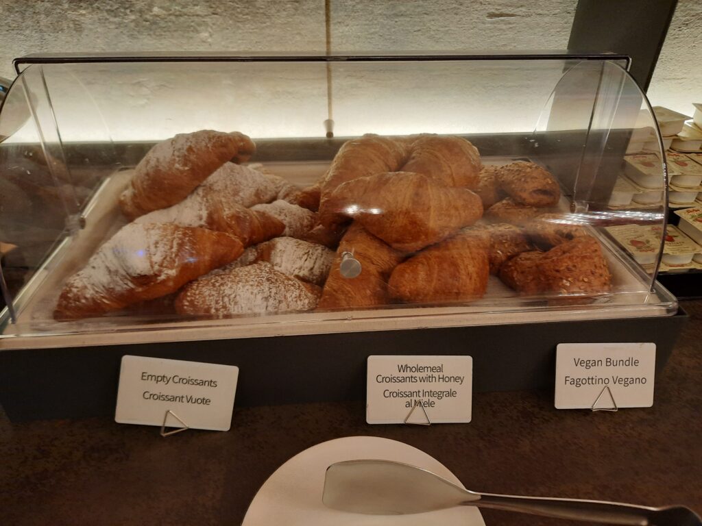 a display case of croissants and other pastries