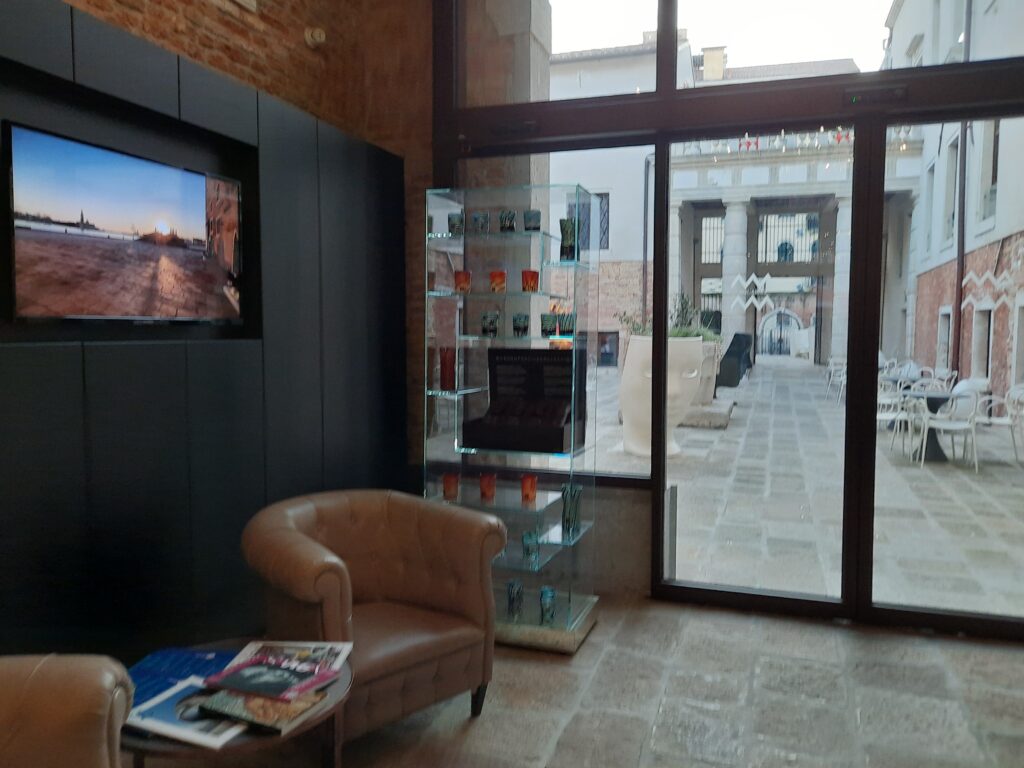 a room with a glass shelf and a chair