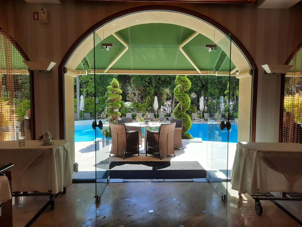 a glass door with a table and chairs outside