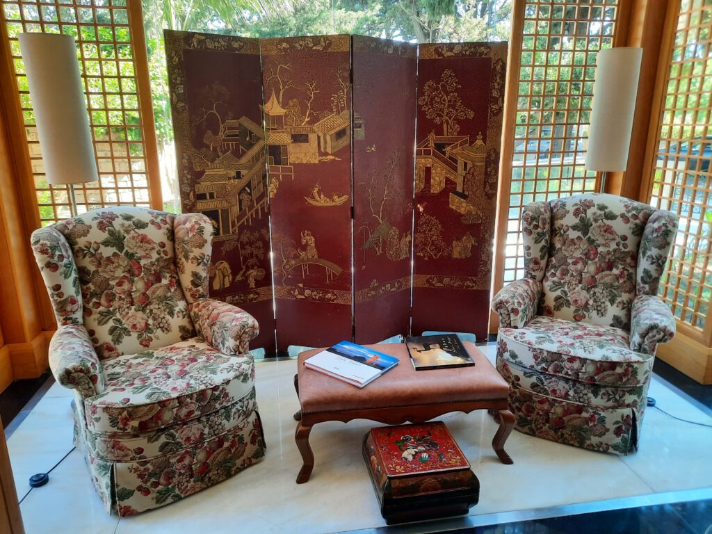 a room with a folding screen and chairs