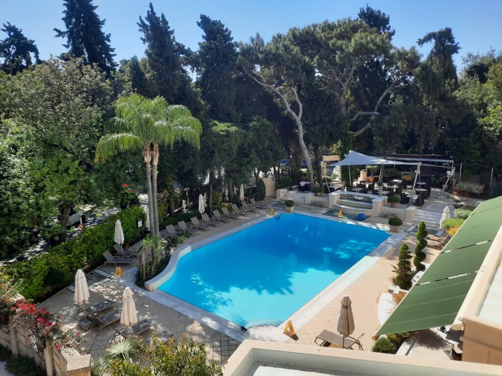 a swimming pool with trees around it