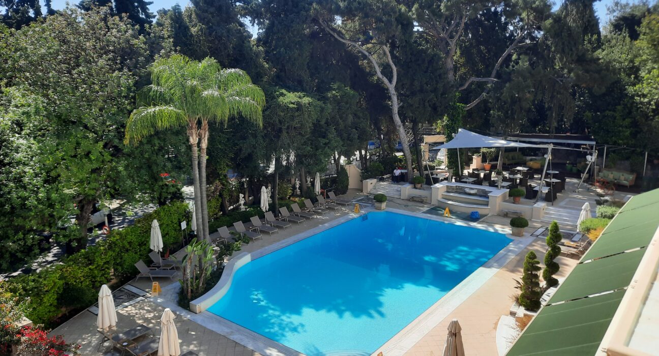 a swimming pool with trees around it