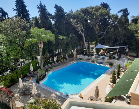 a swimming pool with trees around it