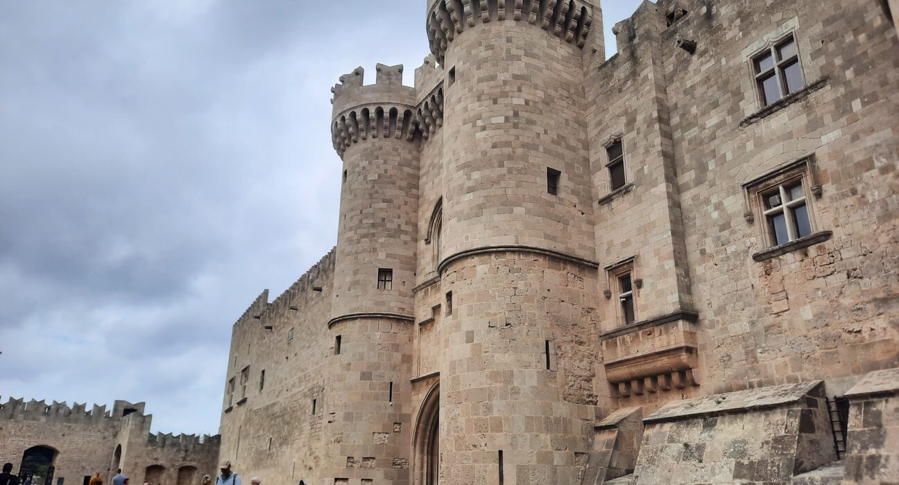 a stone castle with people walking around