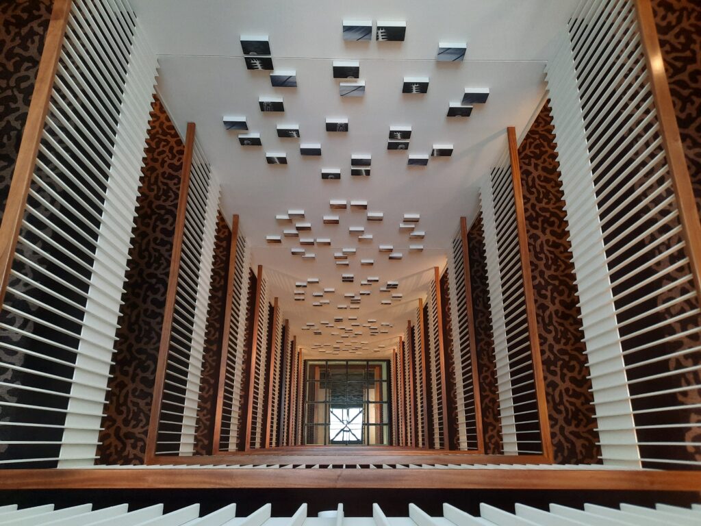 a hallway with white and black blinds