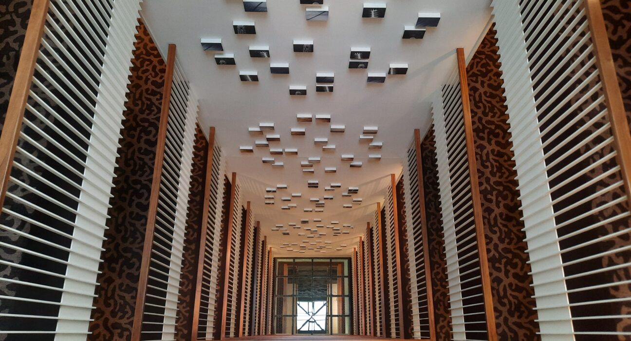 a looking down at a building with white and black wooden slats