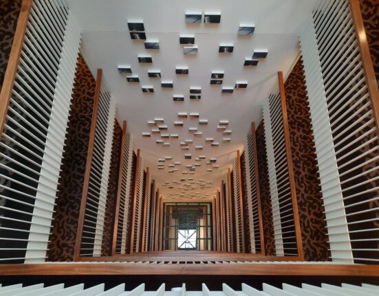 a looking down at a building with white and black wooden slats