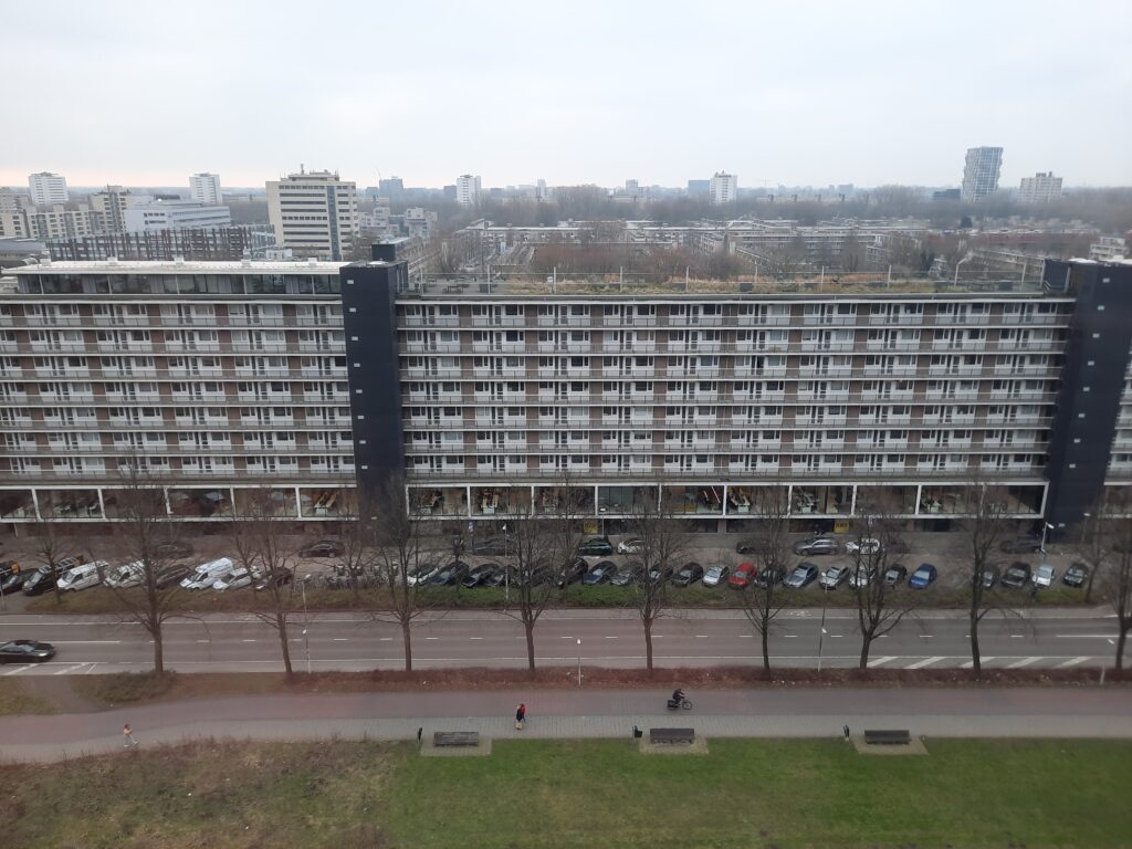 a building with many windows and a parking lot