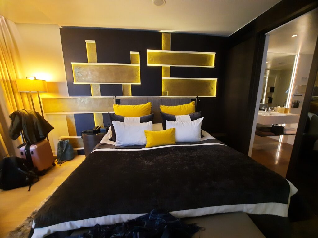 a bed with yellow pillows and a black blanket