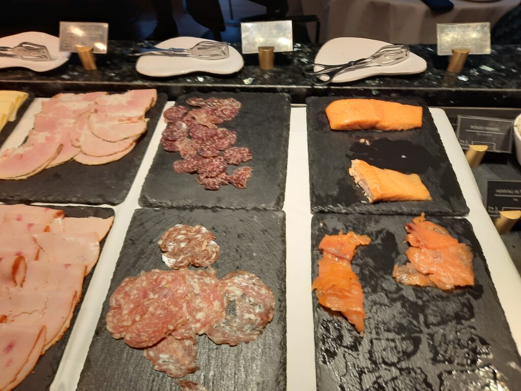 a group of different types of meat on black plates