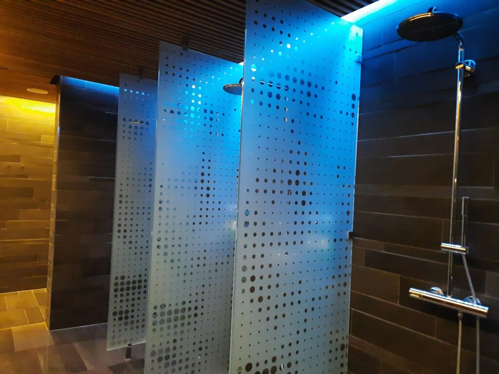 a shower stall with a blue light