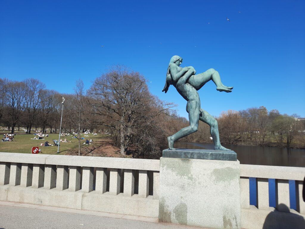 a statue of a man and woman on a bridge