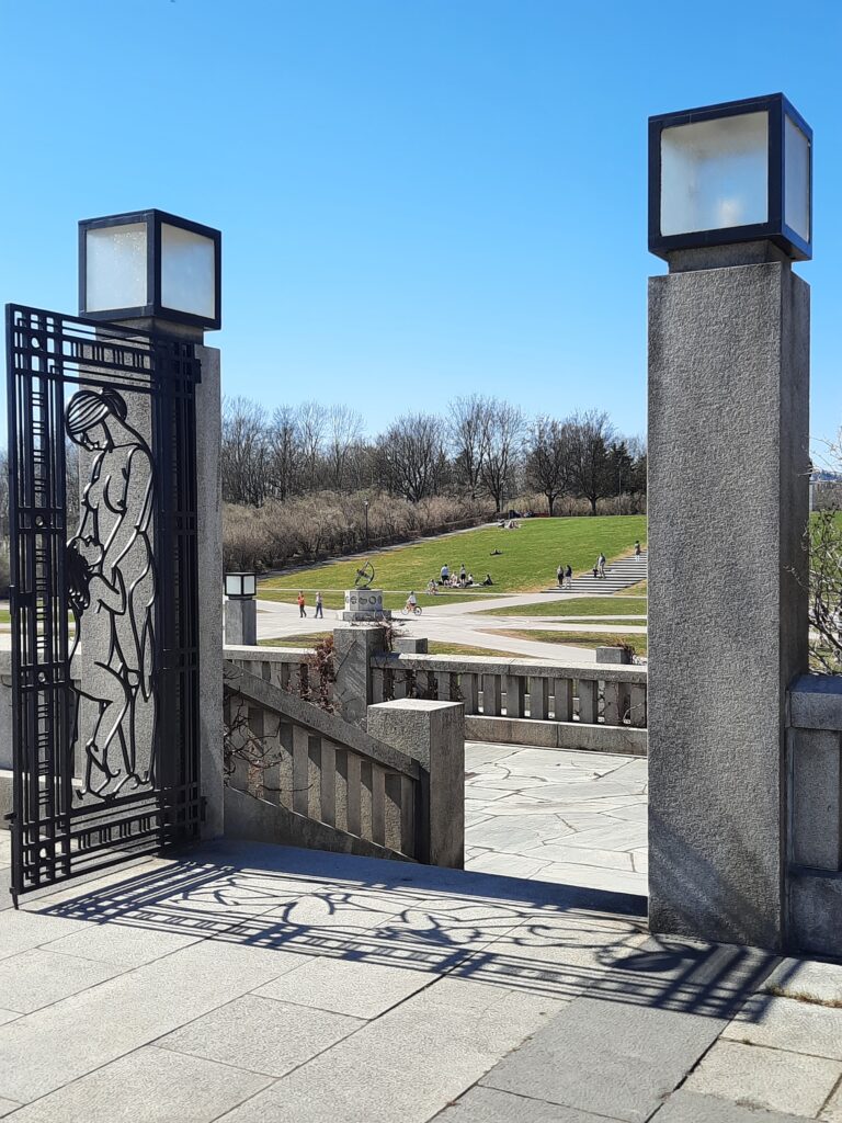 a stone gate with a sculpture on it