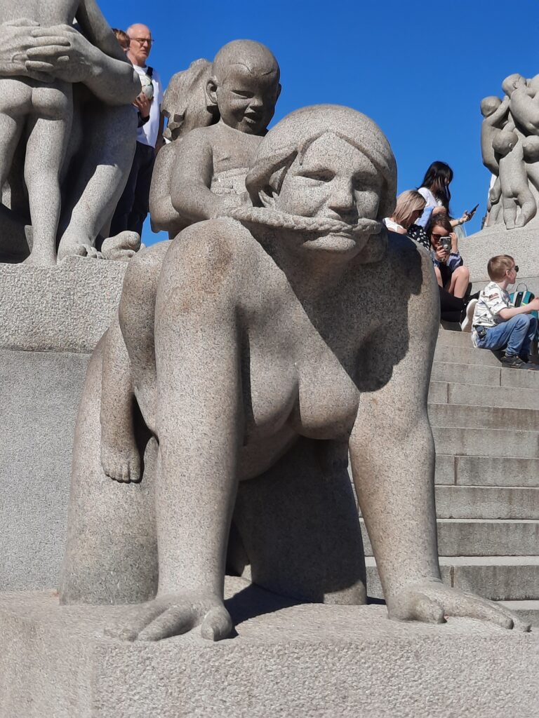 a statue of a woman and a child on her back
